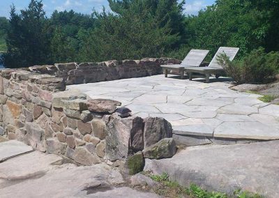 Granite Retaining wall with flagstone patio and steps